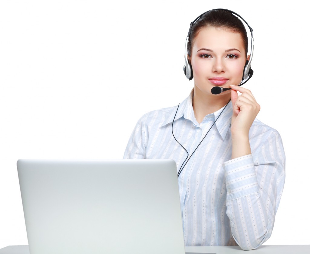 young customer service girl with a headset at her workplace